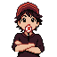 a boy in a cap a lollipop at mouth and folded arms