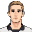 front-facing face reference image only, based on the uploaded face photo. young light-skinned male, short light brown hair slightly darker, long slim face, defined jaw, dark eyebrows, simple readable eyes, calm slight smile, natural ear size, clean 2d gam