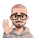 a man with short grade 0 buzz cut all over hair (almost bald with receeding hairline) with thick black glasses, no beard, in a light gray hoody and man is waving to the camera