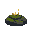 small lit candles on mossy rock