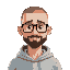 a man with short grade 0 buzz cut all over hair (almost bald with receeding hairline) with thick black glasses, no beard, in a light gray hoody and waving