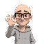 a bald man with thick black glasses in a light gray hoody waving