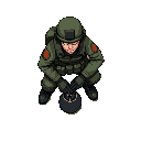 a soldier crouching disarming a bomb