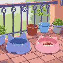two cat feeding bowls on the terrace, a blue one completely empty and a pink one with a bit of food left in it