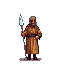 brown man wearing typical desert clothes and a spear-like staff with a light blue time crystal on the tip 