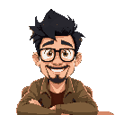 man with medium length dark hair, slightly spiky, short beard, glasses, cheesy smile, sitting in coffee shop with 