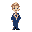 a boy with a blue suit and a blue, white, and red elected official's sash. he is blond